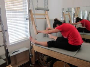 Pilates Push Through uses the Tower Springs for a full-body stretch.